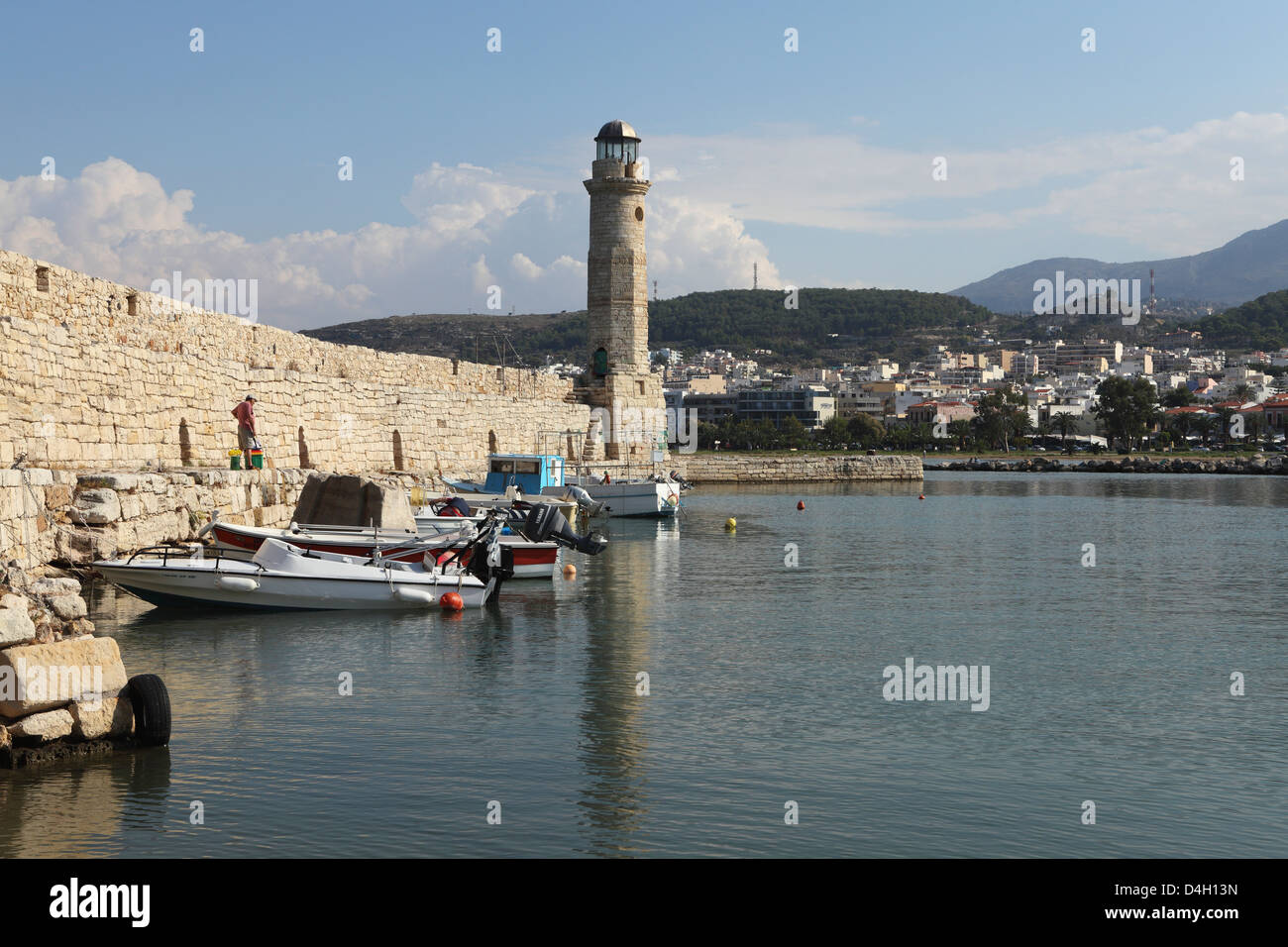 The Venetian era harbour walls and lighthouse at the Mediterranean port of Rethymnon, Crete, Greek Islands, Greece Stock Photo