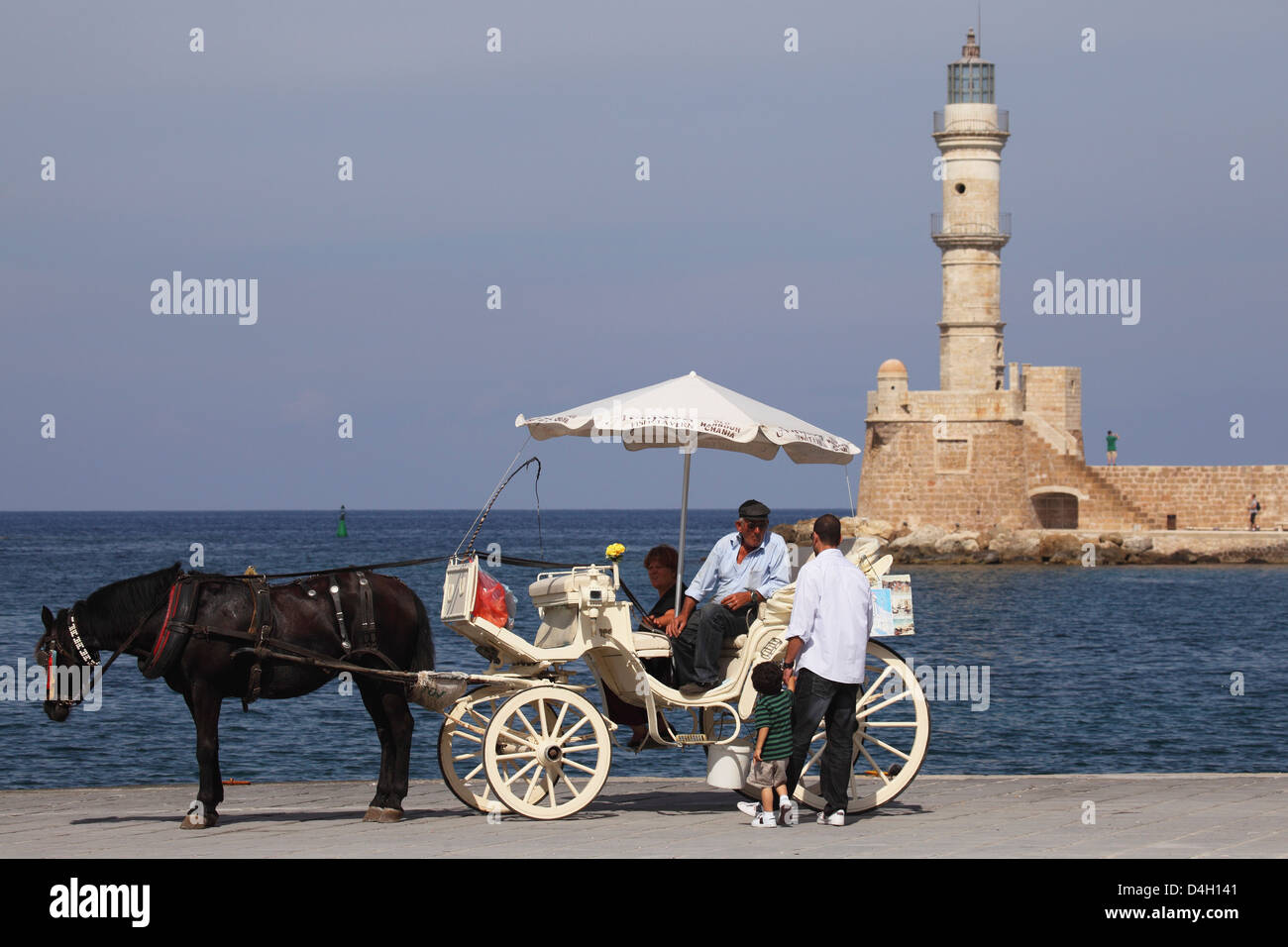 A horse and cart for city tours, at the Venetian era harbour, at the Mediterranean port of Chania, Crete, Greek Islands, Greece Stock Photo