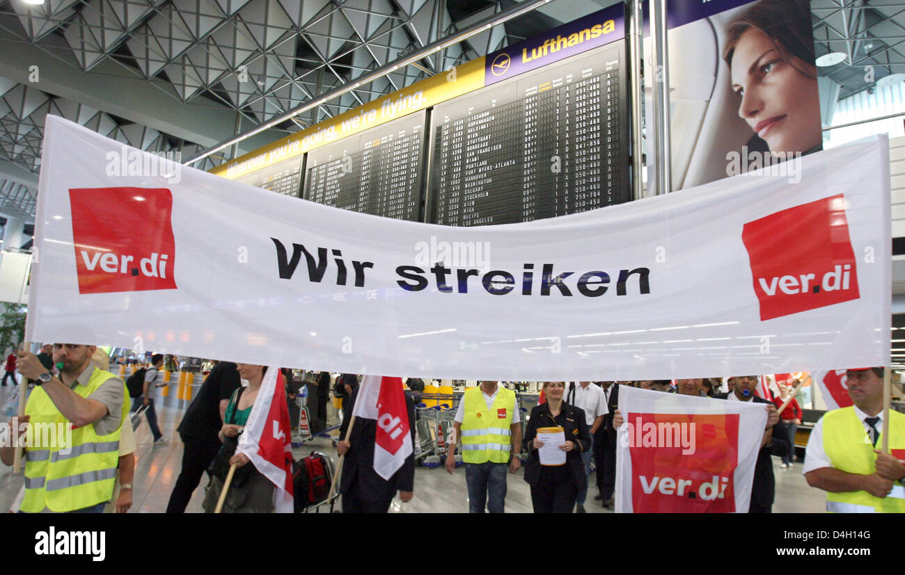 Lufthansa employees holding a strike banner are pictured at the departure hall of the airport in Frankfurt Main, Germany, 28 July 2008. The German trade union 'ver.di' called all Lufthansa employees out on the most extensive strike in 13 years. The union demands for the 50,000 employees 9.8 per cent more money for one year. So far Lufthansa offered 7.7 per cent for a period of 21 m Stock Photo