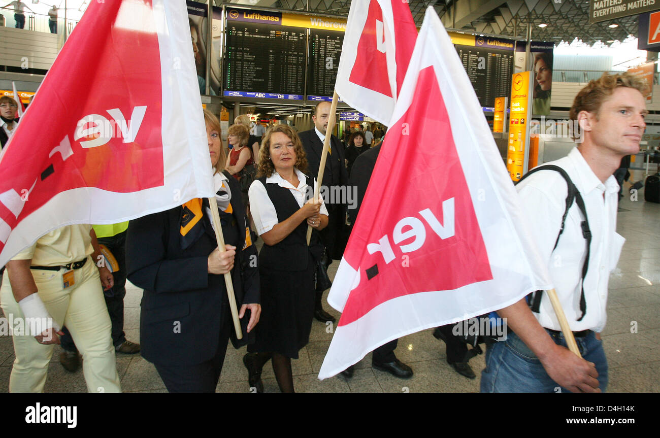 Lufthansa employees holding a strike banner are pictured at the departure hall of the airport in Frankfurt Main, Germany, 28 July 2008. The German trade union 'ver.di' called all Lufthansa employees out on the most extensive strike in 13 years. The union demands for the 50,000 employees 9.8 per cent more money for one year. So far Lufthansa offered 7.7 per cent for a period of 21 m Stock Photo