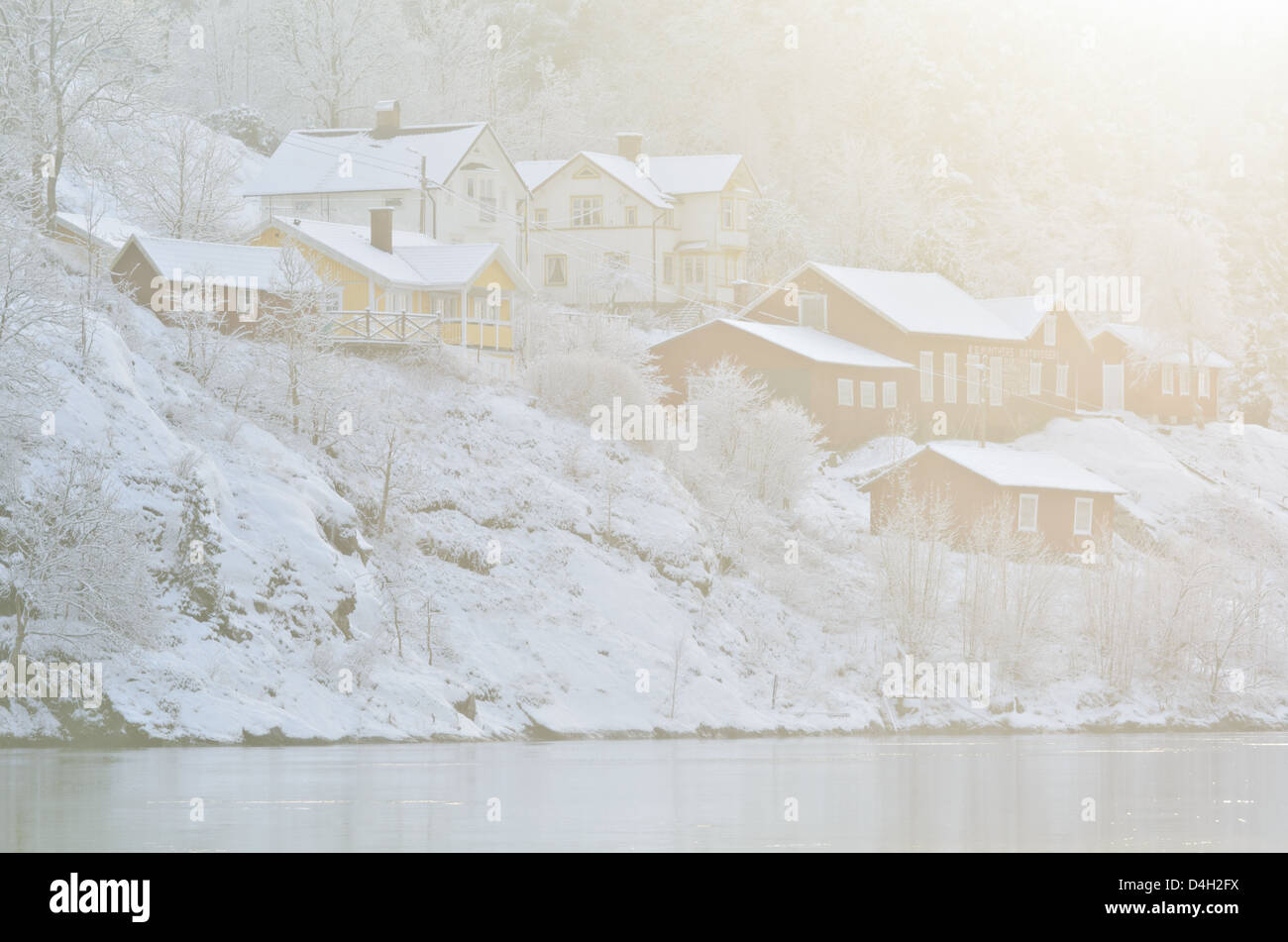 Mist over lakeside buildings along the Göta Älv, Sweden, Europe Stock Photo