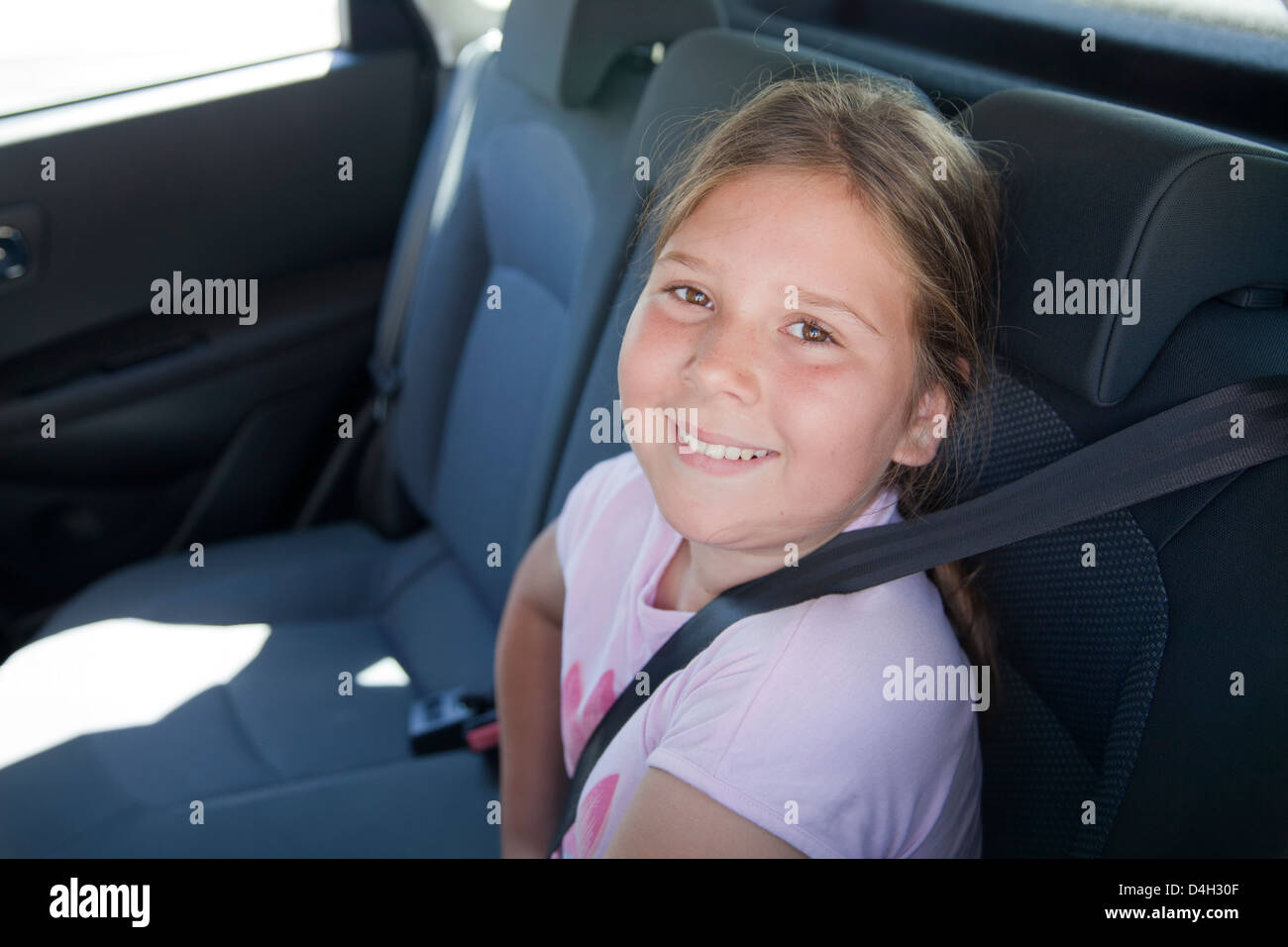 Girl sitting in backseat of Car with seatbelt Stock Photo Alamy