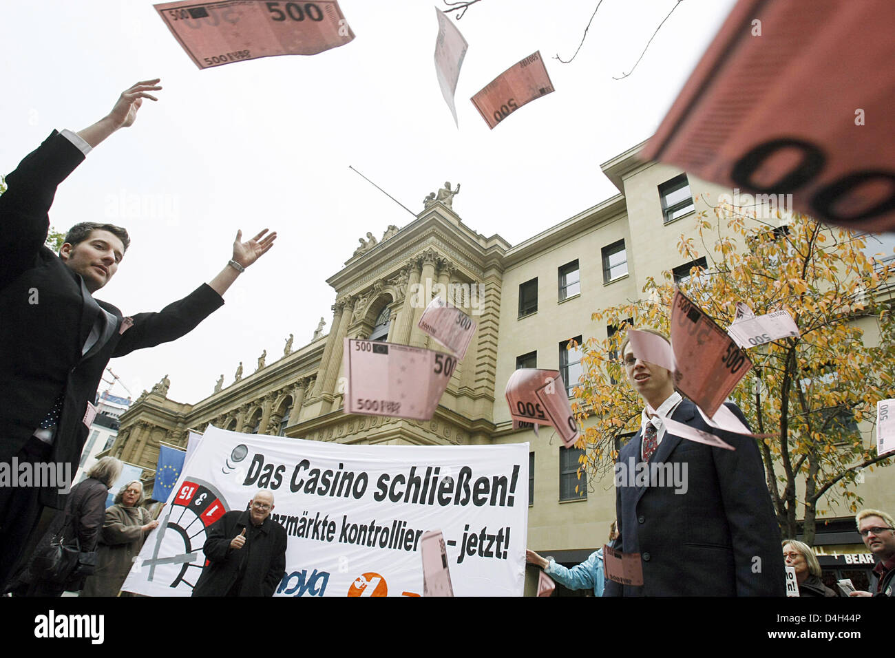 Members of activist organisation 'attac' demonstrate with fake bank notes and a banner reading 'Shut down the casino! Control financial markets now!' outside Frankfurt Stock Exchange in Frankfurt Main, Germany, 22 October 2008. 'Attac' calls for a change of system and massive investments into the social infrastructure, in order to ease sozial consequences of the economic crisis. Ph Stock Photo