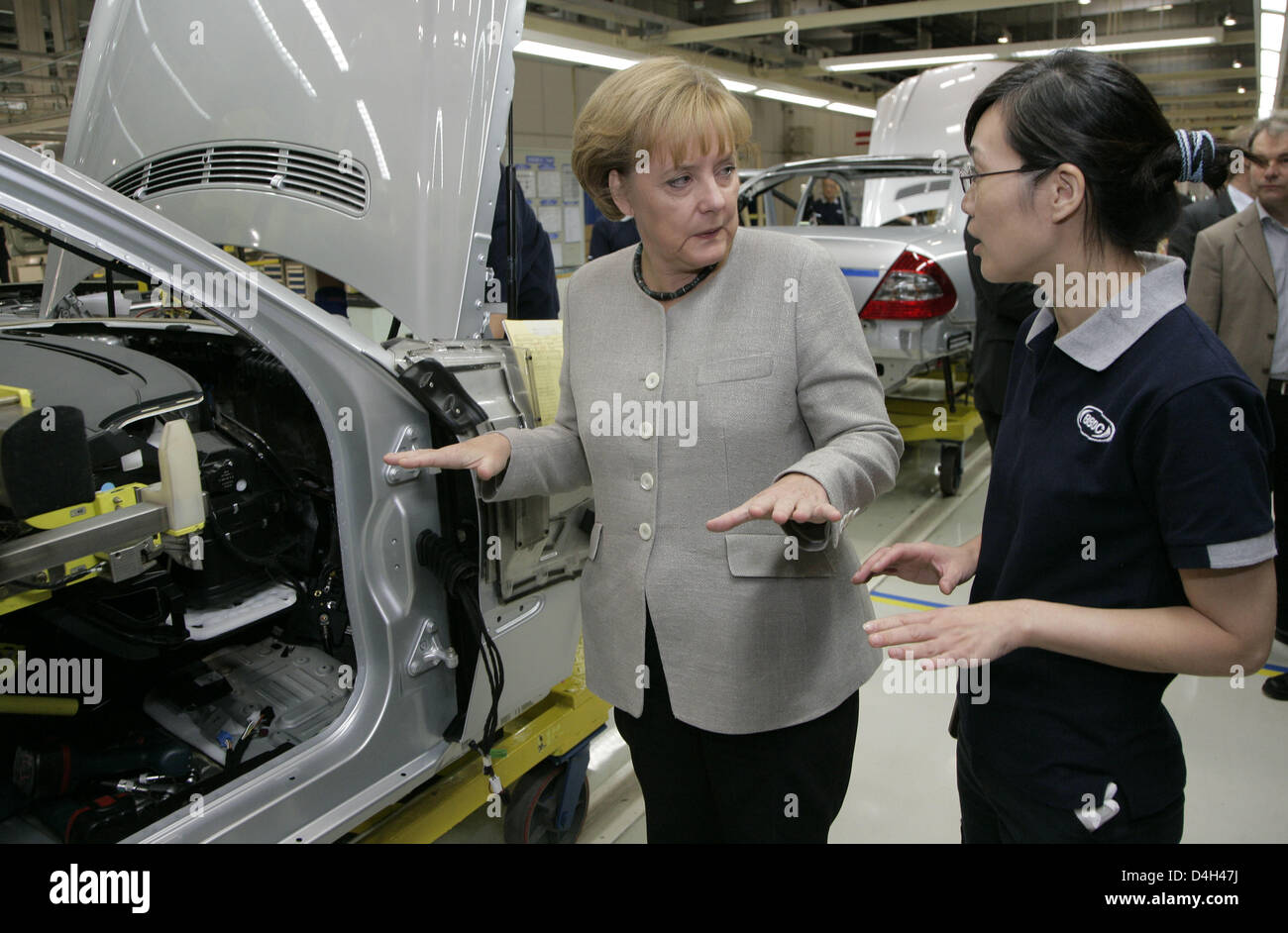 German Chancellor Angela Merkel visits the Mercedes-Benz factory when vehicle no. 25,000 is being produced in Beijing, China, 23 October 2008. Merkel will hold bilateral talks and attend the Asia-Europe Meeting (ASEM) during her three-day stay at the chinese capital. Photo: Peer Grimm Stock Photo