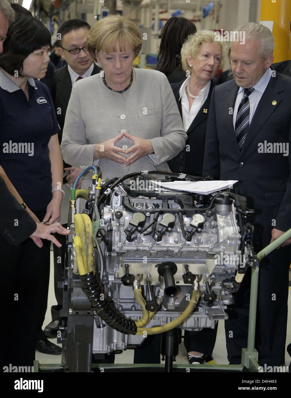 German Chancellor Angela Merkel stands next to Ruediger Grube (R), bord member of Daimler AG, during her visit at the Mercedes-Benz factory when vehicle no. 25,000 is being produced in Beijing, China, 23 October 2008. Merkel will hold bilateral talks and attend the Asia-Europe Meeting (ASEM) during her three-day stay at the chinese capital. Photo: Peer Grimm Stock Photo