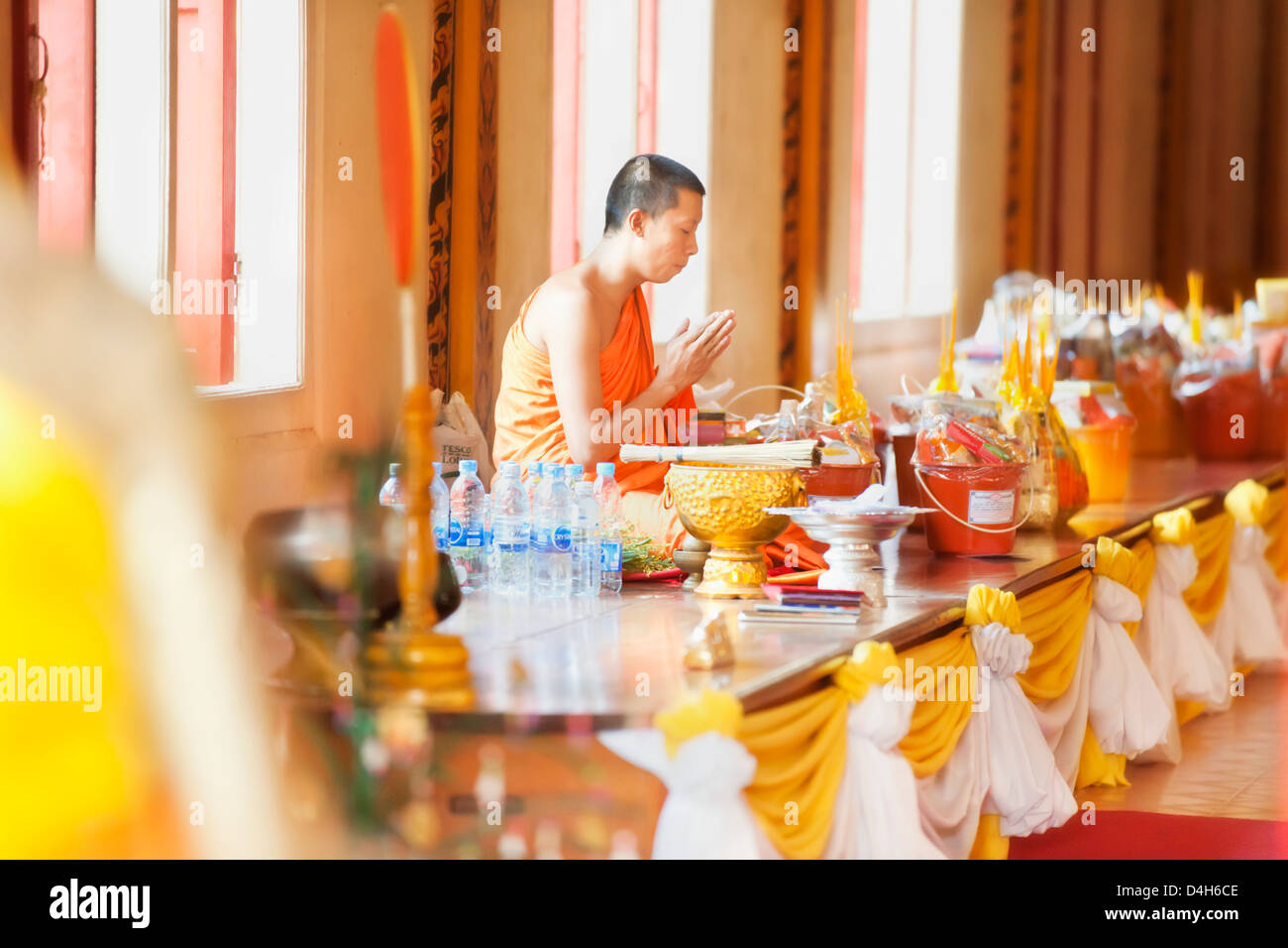 Buddhist monk in prayer in Buddhist Temple, Karon Beach, Phuket Island