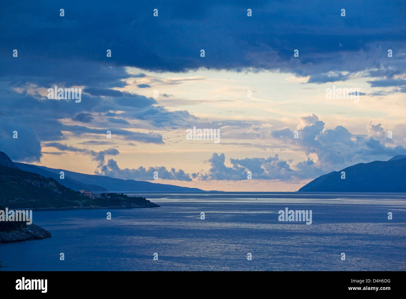 near Skala, island of Kefalonia, Greece: Ionian Sea with Kefalonia on left, Greek mainland on right, dramatic clouds near sunset Stock Photo