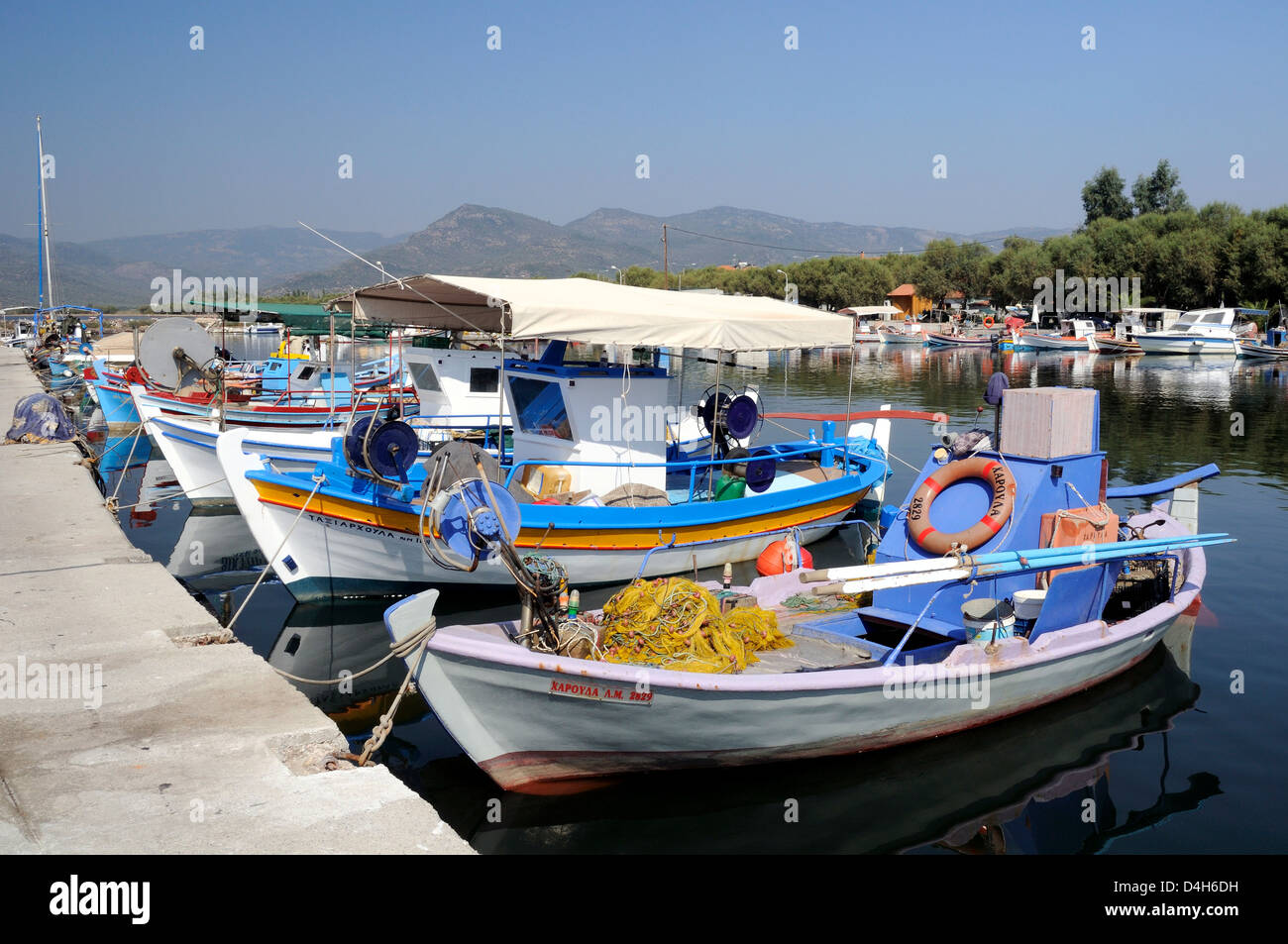 Traditional wooden fishing boats moored in Skala Kalloni harbour, Lesbos (Lesvos), Greek Islands, Greece Stock Photo