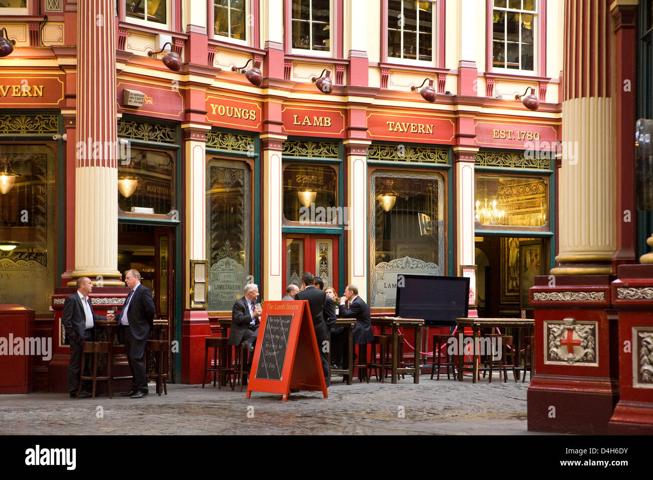 Business people drinking after work at pub in Leadenhall Market (designed 1881 by Sir Horace Jones), The City, London, England Stock Photo