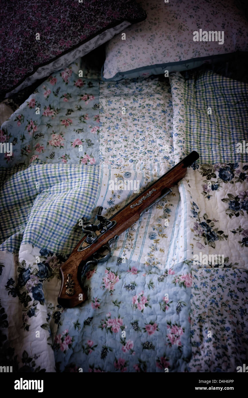 an antique rifle on a vintage bed Stock Photo