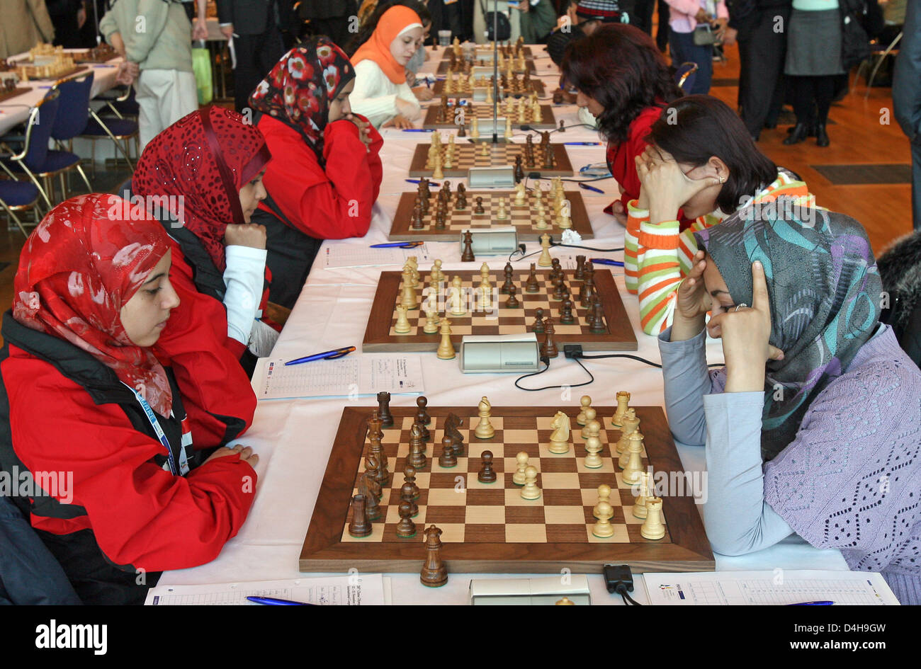 Eight-year-old Tim Wagner stands in front of ?his? poster and smiles during  the 2008 Chess Olympiad in Dresden, Germany, 15 November 2008. His is one  of the face represented during the advertisement