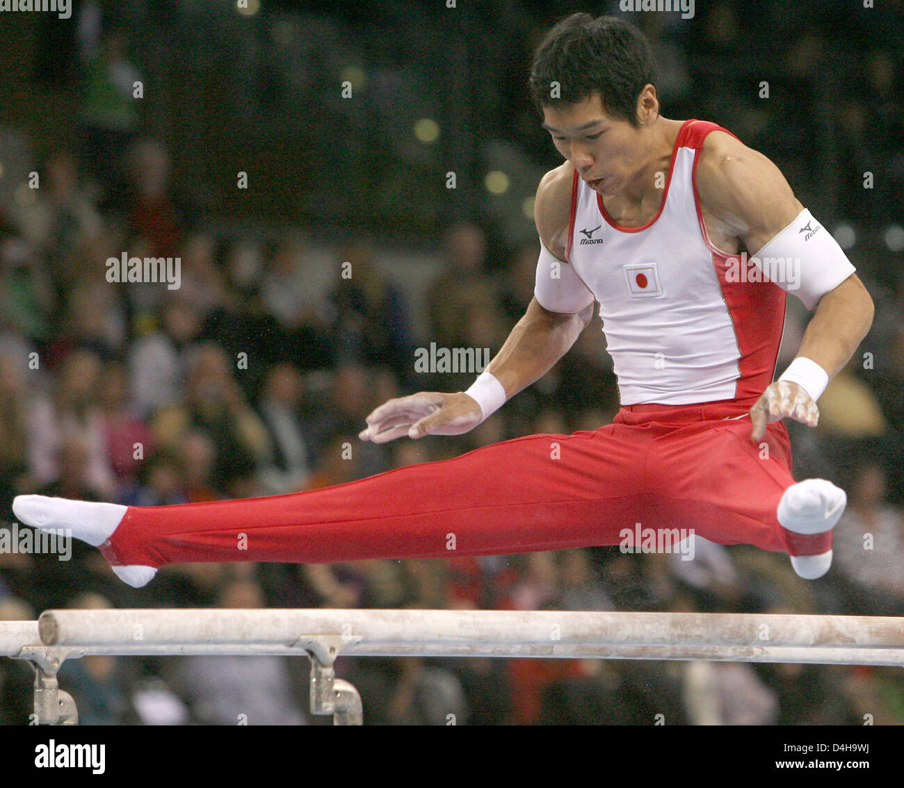 Japanese artistic gymnast Hisashi Mizutori performs on the parallel bars during the 26th DTB (?Germany?s Artistic Gymnastics Association?) Champions Trophy at Porsche-Arena in Stuttgart, Germany, 16 November 2008. He placed second in the all-around competition. Photo: NORBERT FOERSTERLING Stock Photo