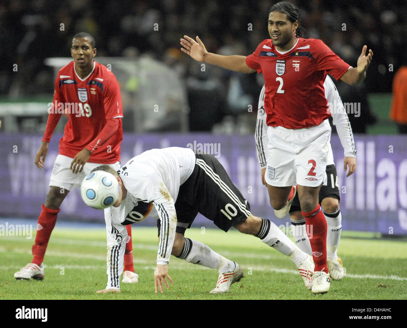 English national players shley Young (L) and Glen Johnson vie for the ball with German Lukas Podolski (C) during the friendly match at Olympiastadium in Berlin, Germany, 19 November 2008. England defeated Germany 2-1. Photo: Jochen Luebke Stock Photo