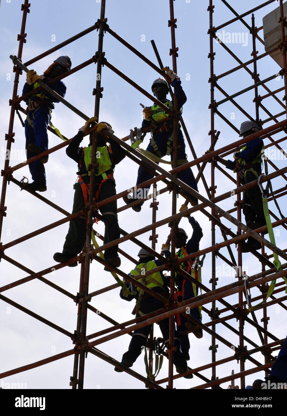 Construction workers are pictured on a scaffold at Royal Bafokeng