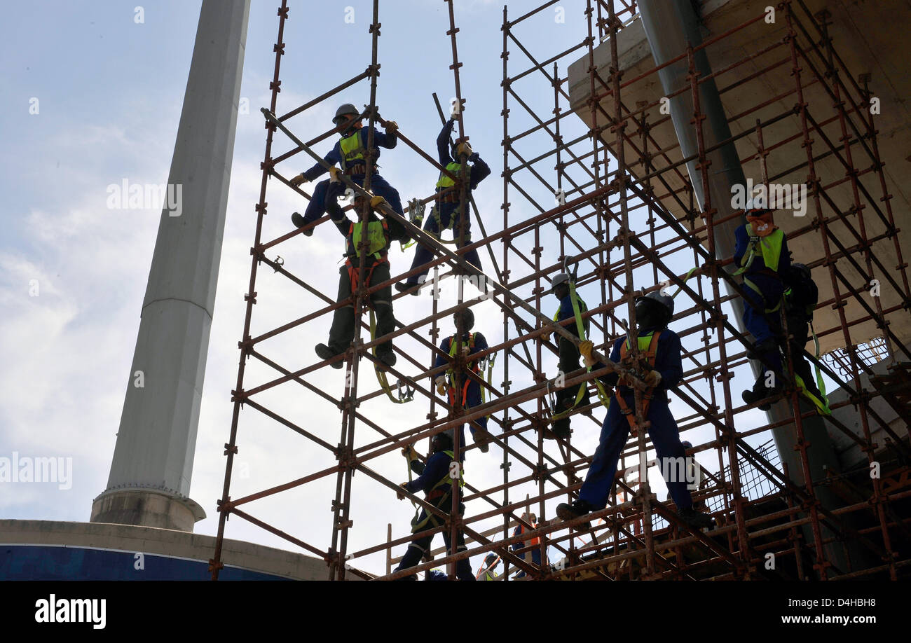 Construction workers are pictured on a scaffold at Royal Bafokeng