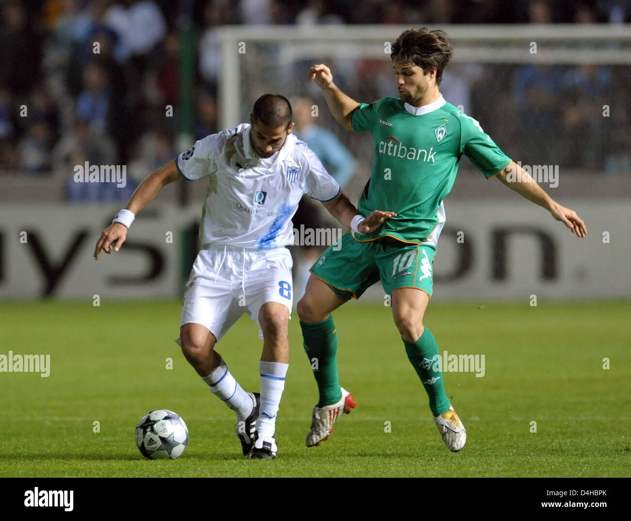 Diego (R) of Werder Bremen vies for the ball with Ioannis Skopelitis of  Anorthosis Famagusta during the Champions League group B match at GSP  Stadium in Nicosia, Cyprus, 26 November 2008. The