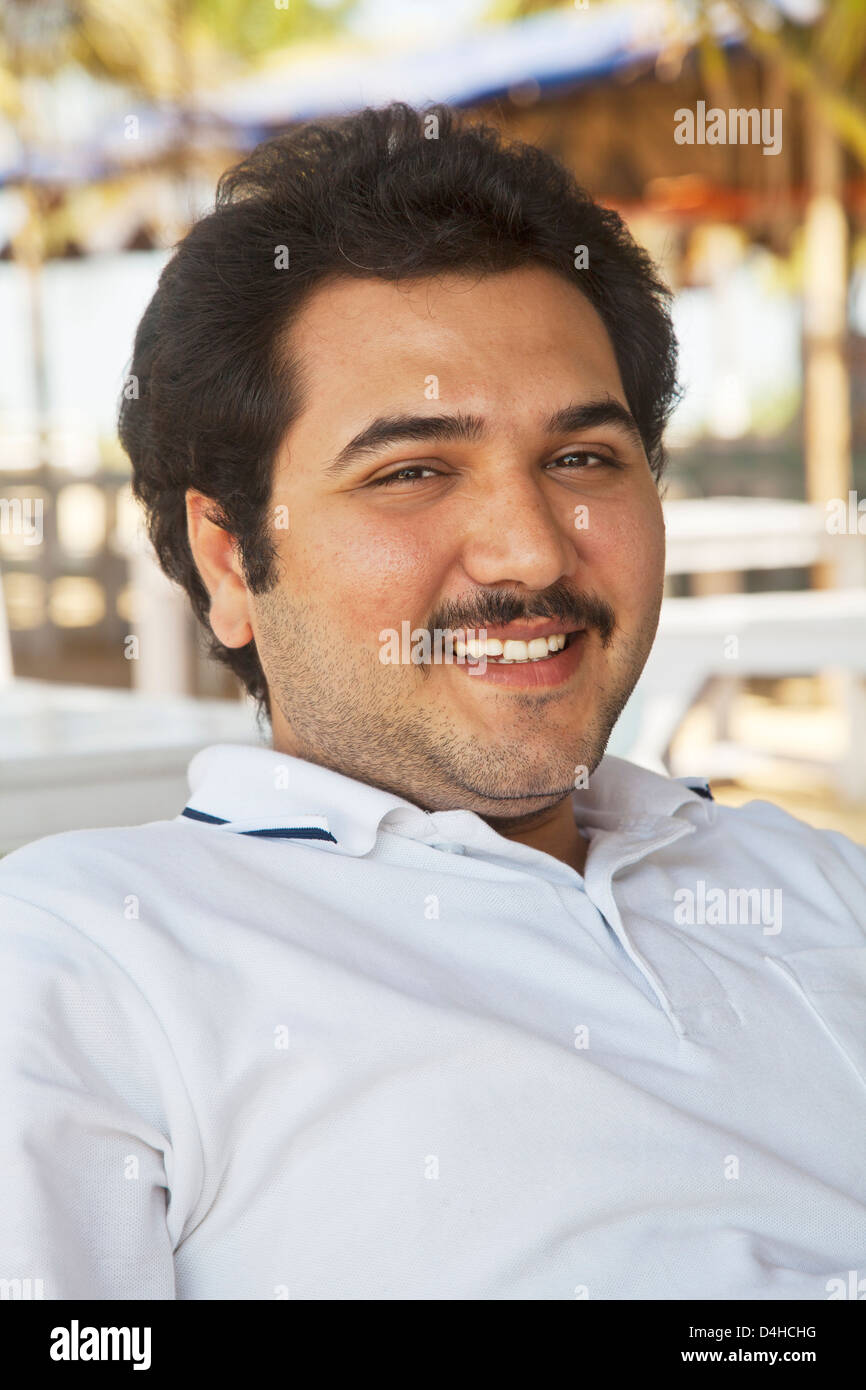 smiling young adult male, combed back hair, mustache, unshaved, celebrity look a like, Stock Photo