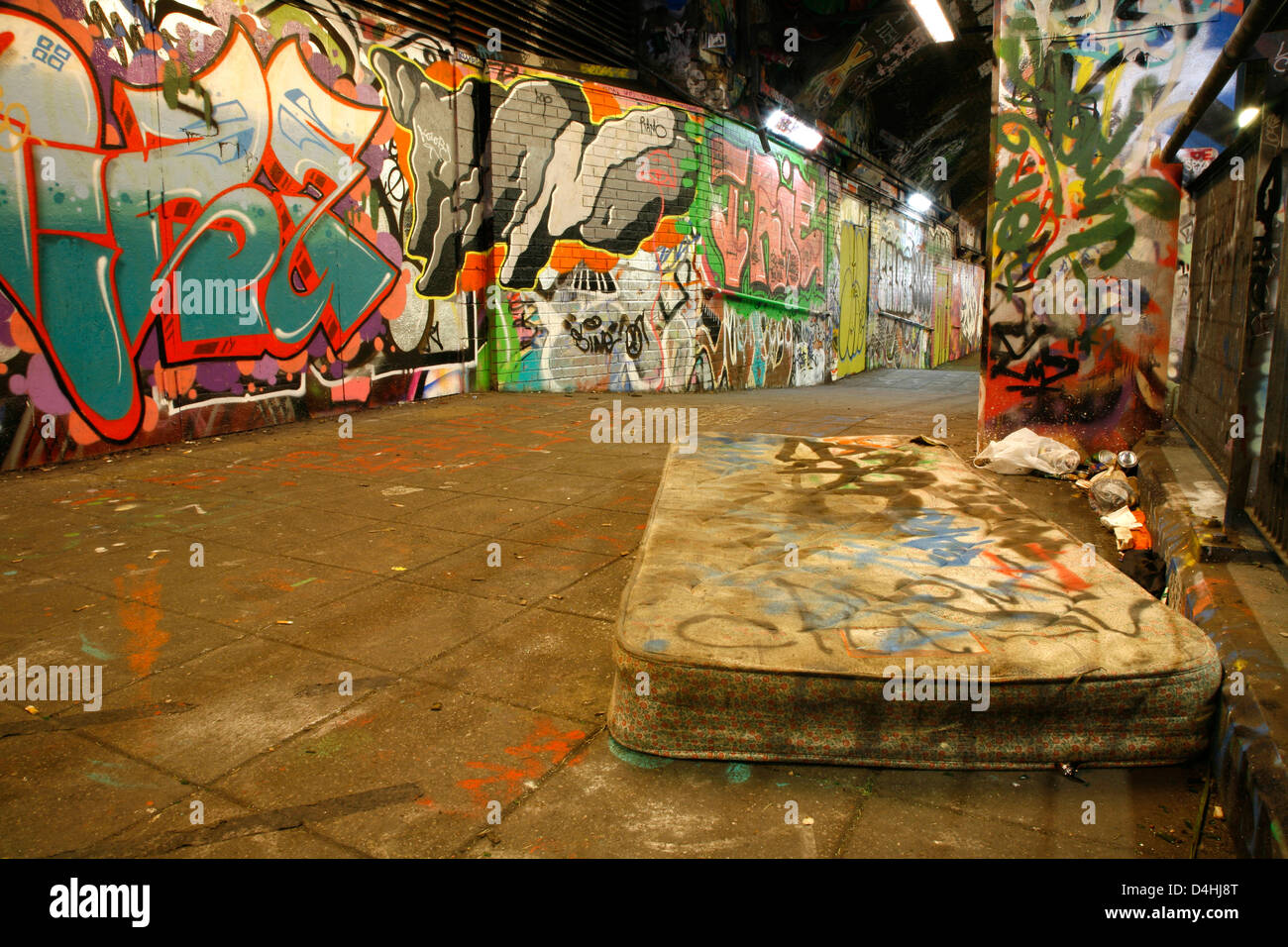 Graffiti-covered walls and mattress in Leake Street underneath Waterloo Station, Waterloo, London, UK Stock Photo