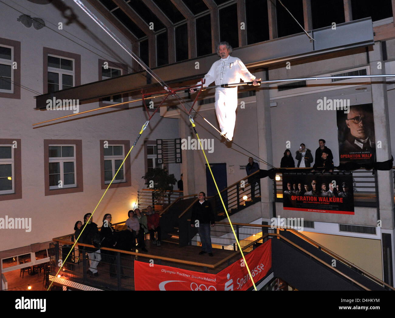 High-wire artist Falko Traber walks a tightrope at the film premiere of ?Man On Wire - The Tightrope? at the cinema ?Harmonie? in Freiburg, Germany, 23 January 2009. The documentary tells the story of French Philippe Petit, who walked a tightrope between the Twin Towers (the world?s two highest towers at that time) of the World Trade Centre in New York, USA on 07 August 1974. Photo Stock Photo