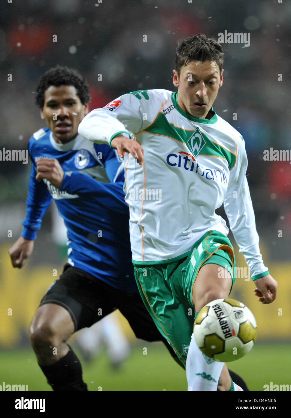 Bremen?s Mesut Oezil (front) fights for the ball with Bielefeld?s Michael Lamey during the Bundesliga match Werder Bremen vs Arminia Bielefeld at Weser stadium in Bremen, Germany, 01 February 2009. Bielefeld defeated Bremen 2-1. Photo: CARMEN JASPERSEN (ATTENTION: BLOCKING PERIOD! The DFL permits the further utilisation of the pictures in IPTV, mobile services and other new technol Stock Photo