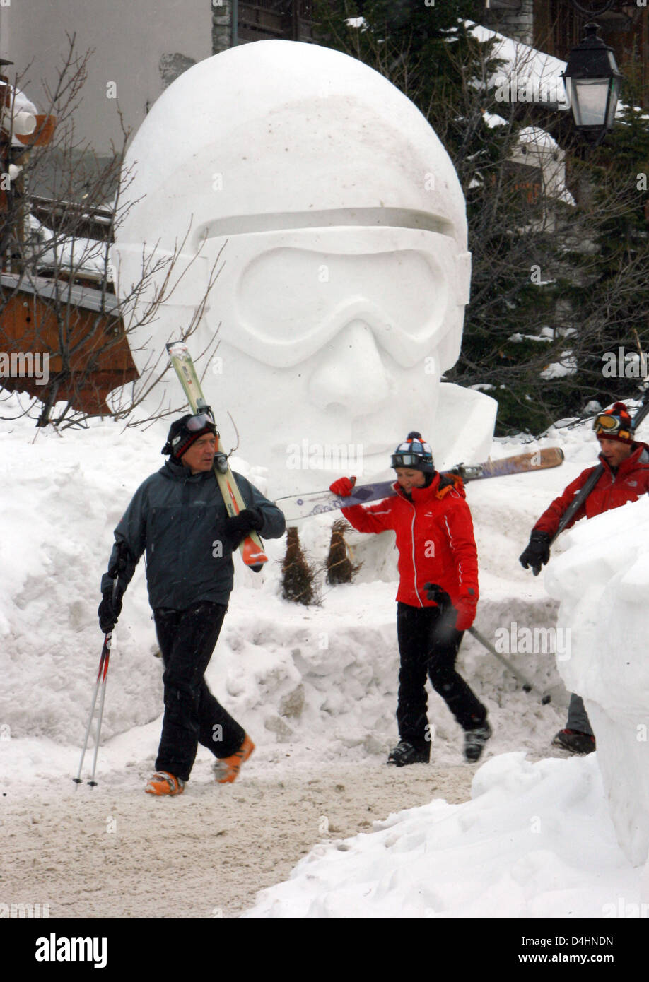 Skiers pass a snow sculpture at the skiing resort Val d?Isere ...