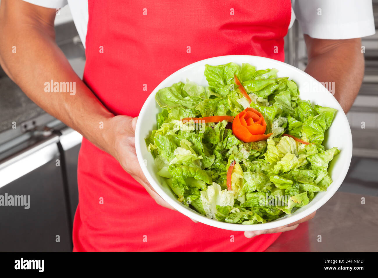 Chef Presenting Salad In Kitchen Stock Photo Alamy