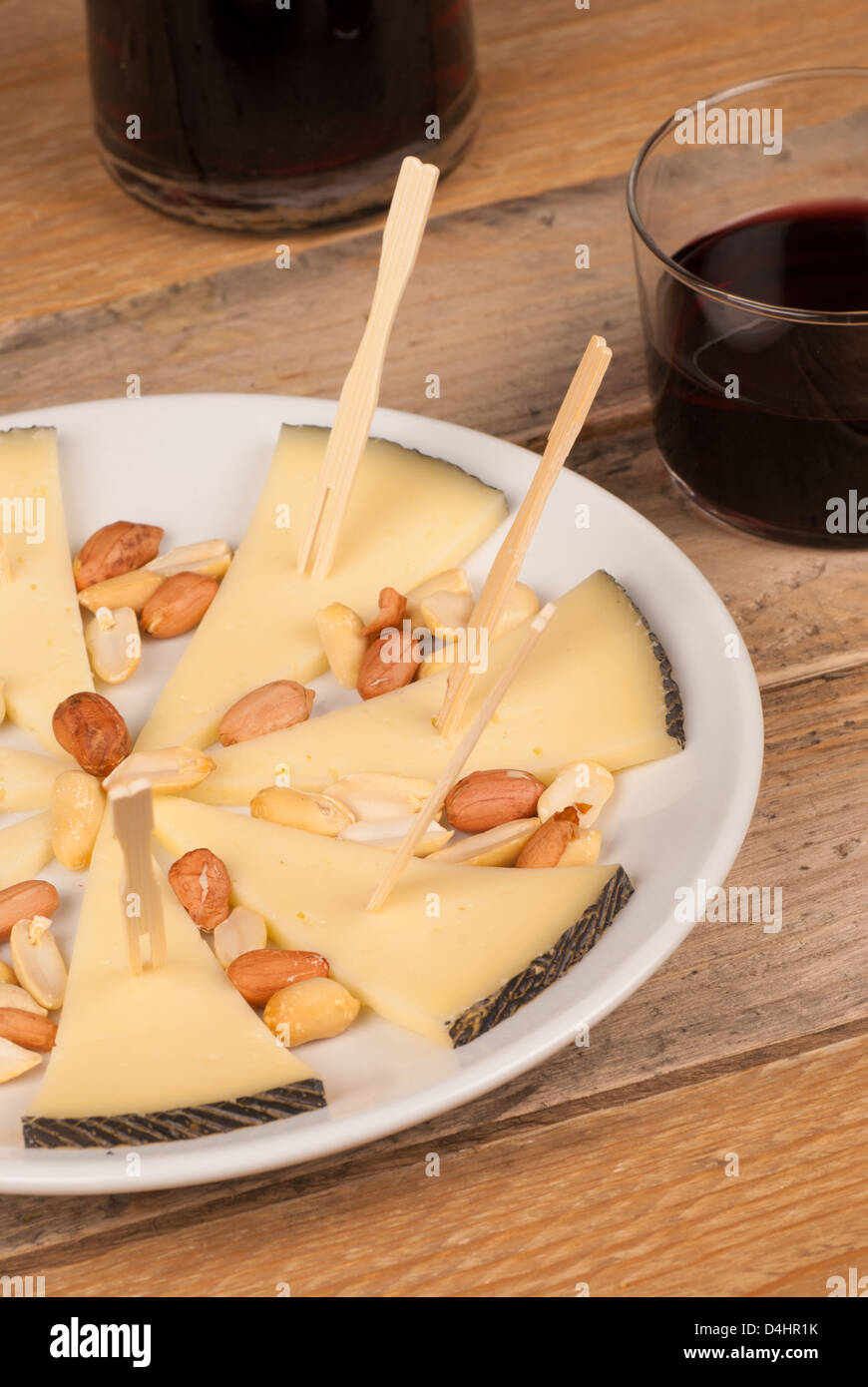 Traditional manchego cheese tapa served with red wine Stock Photo Alamy