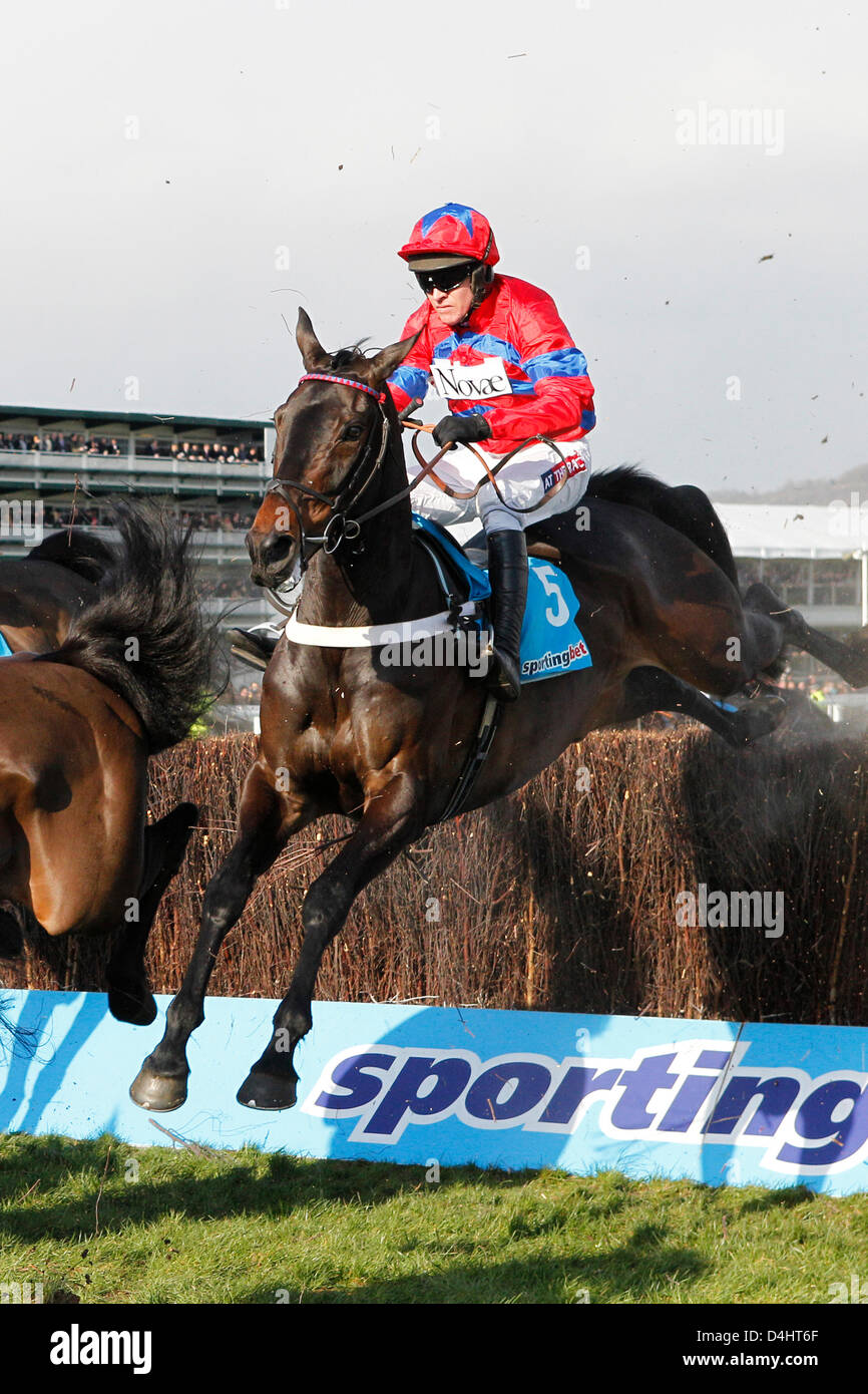 Cheltenham, UK. 13th March 2013.  Sprinter Sacre, ridden by Barry Geraghty (right, red) jumping the fence at the sportingbet.com Queen Mother Champion Chase Grade 1. Credit:  dpa picture alliance / Alamy Live News Stock Photo