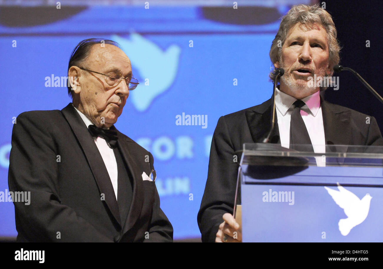 Pink-Floyd bassist Roger Waters (R) receives the ?Honoring Award? by former German Foreign Minister Hans-Dietrich Genscher at the ?Cinema for Peace? gala at the 59th Berlin International Film Festival in Berlin, Germany, 09 February 2009. ?Cinema for Peace? is a worldwide initiative promoting humanity through film. Members of the international film community have created a platform Stock Photo