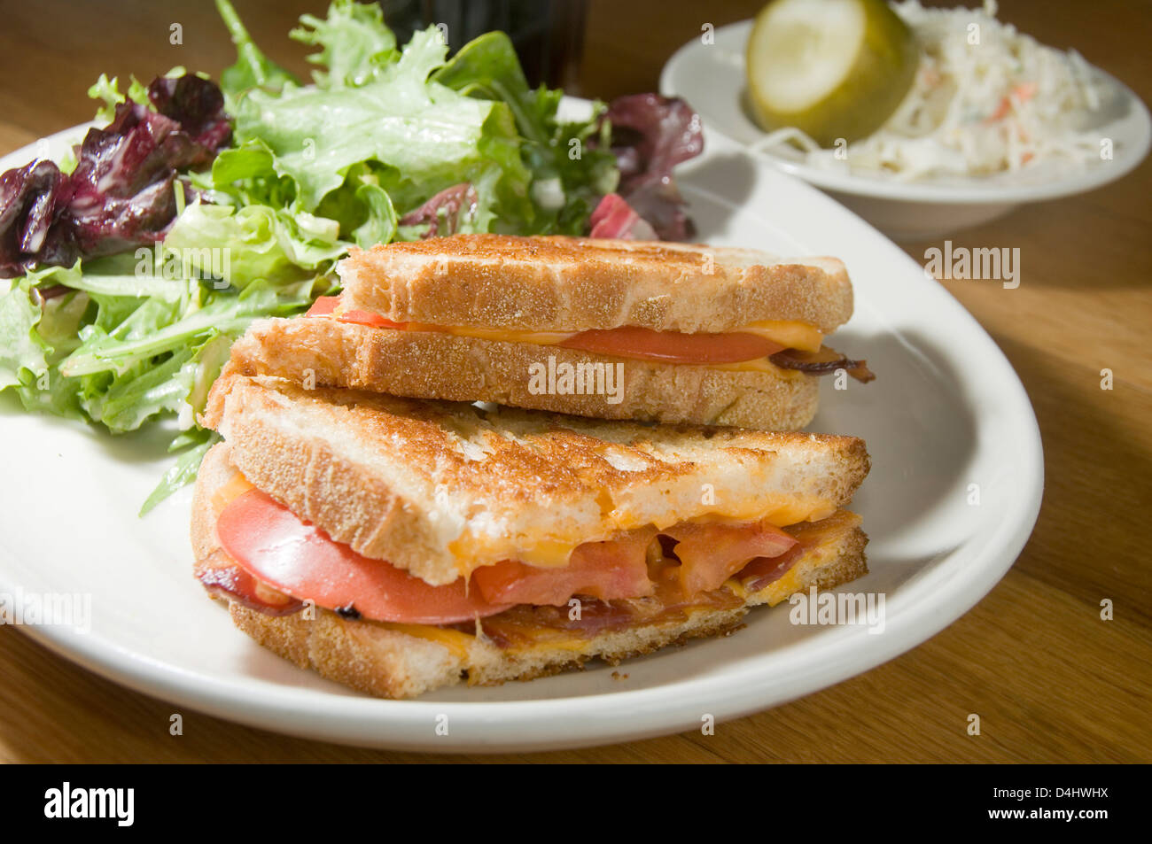 Grilled Cheese Sandwich Bacon Tomato With Vinaigrette Salad And Coleslaw Dill Pickle Stock Photo Alamy