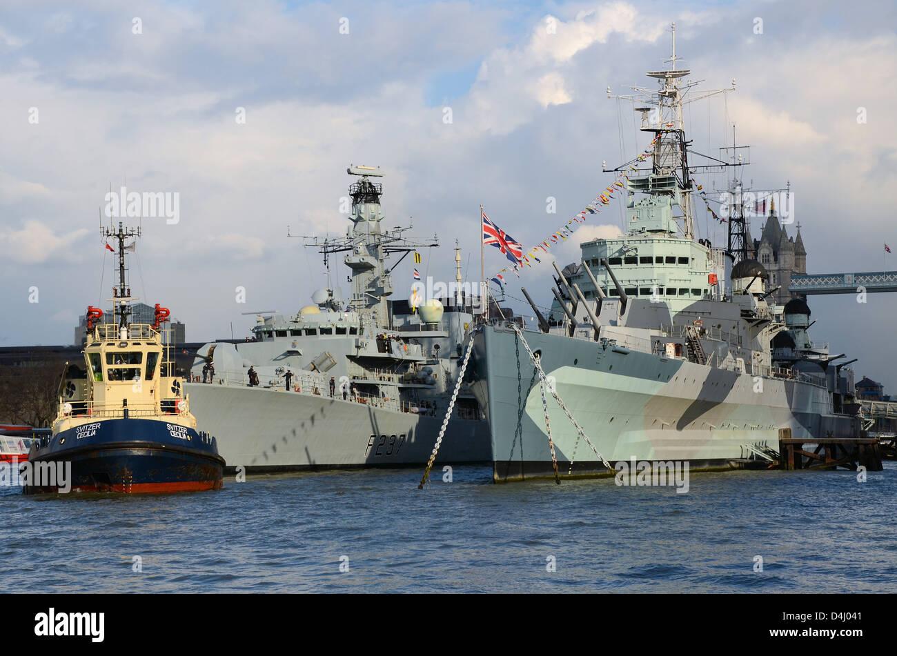 Royal Navy Type 23 frigate HMS Westminster moored alongside IWM museum ship HMS Belfast for the latter's 75th anniversary Stock Photo