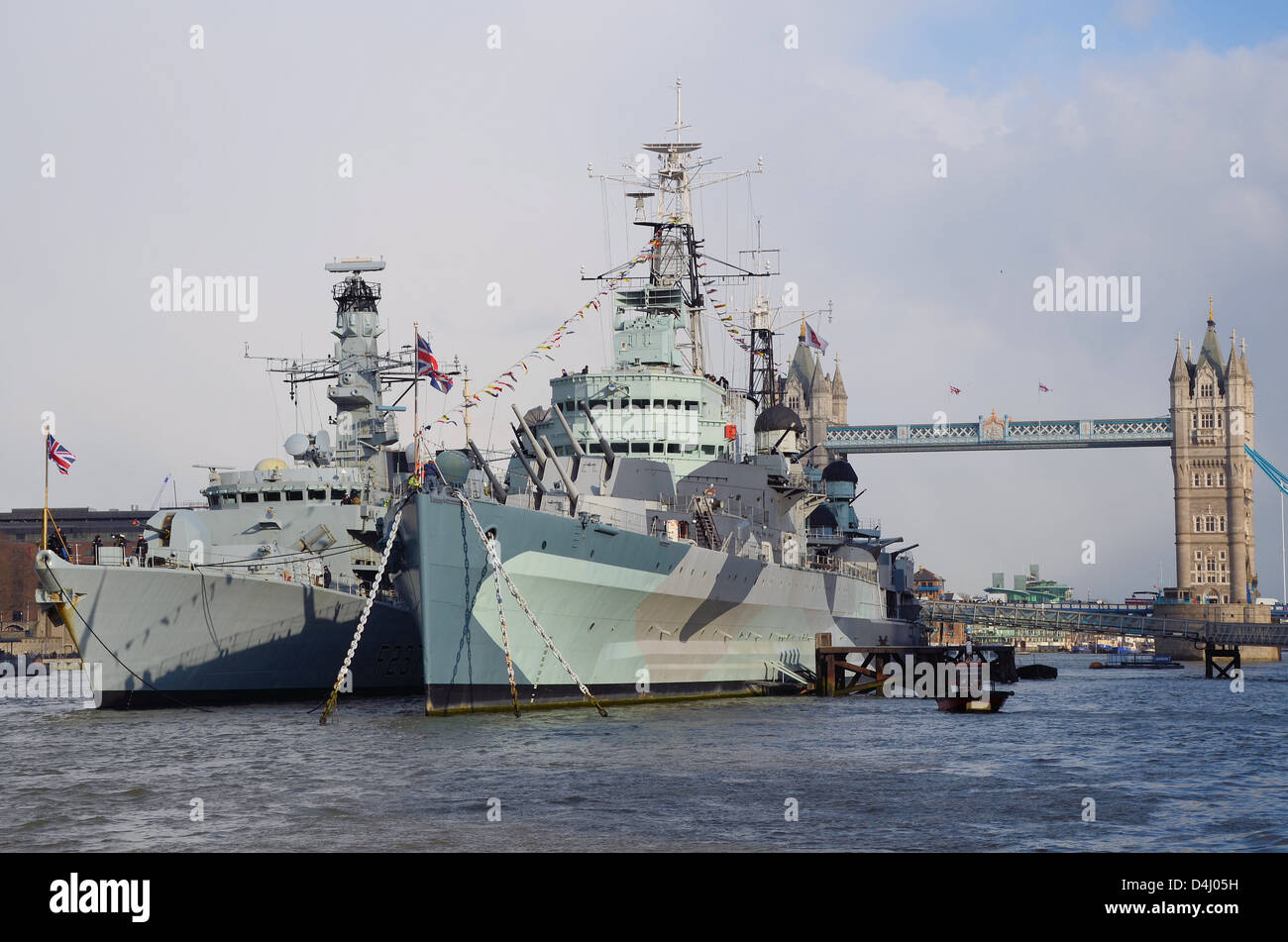 Current Royal Navy Type 23 frigate HMS Westminster moored alongside IWM museum ship HMS Belfast for the latter's 75th anniversary Stock Photo
