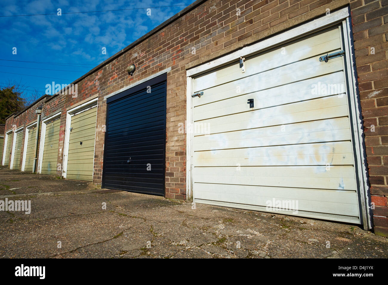 Row of Garages with metal doors Danesgate Lincoln Lincolnshire England Stock Photo