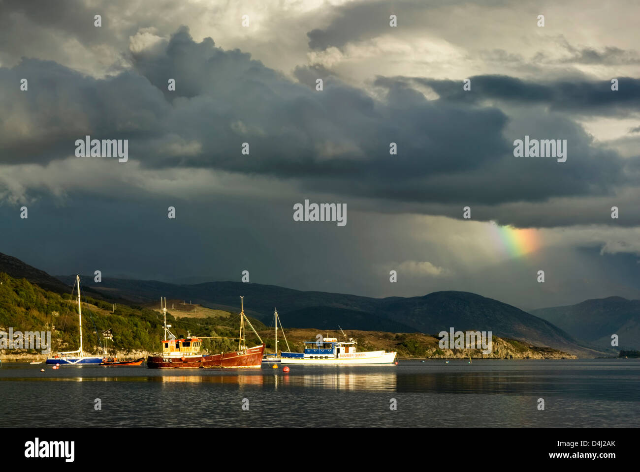 Storm clouds with rainbow over Highland mountains from Ullapool. Highlands, Scotland Stock Photo