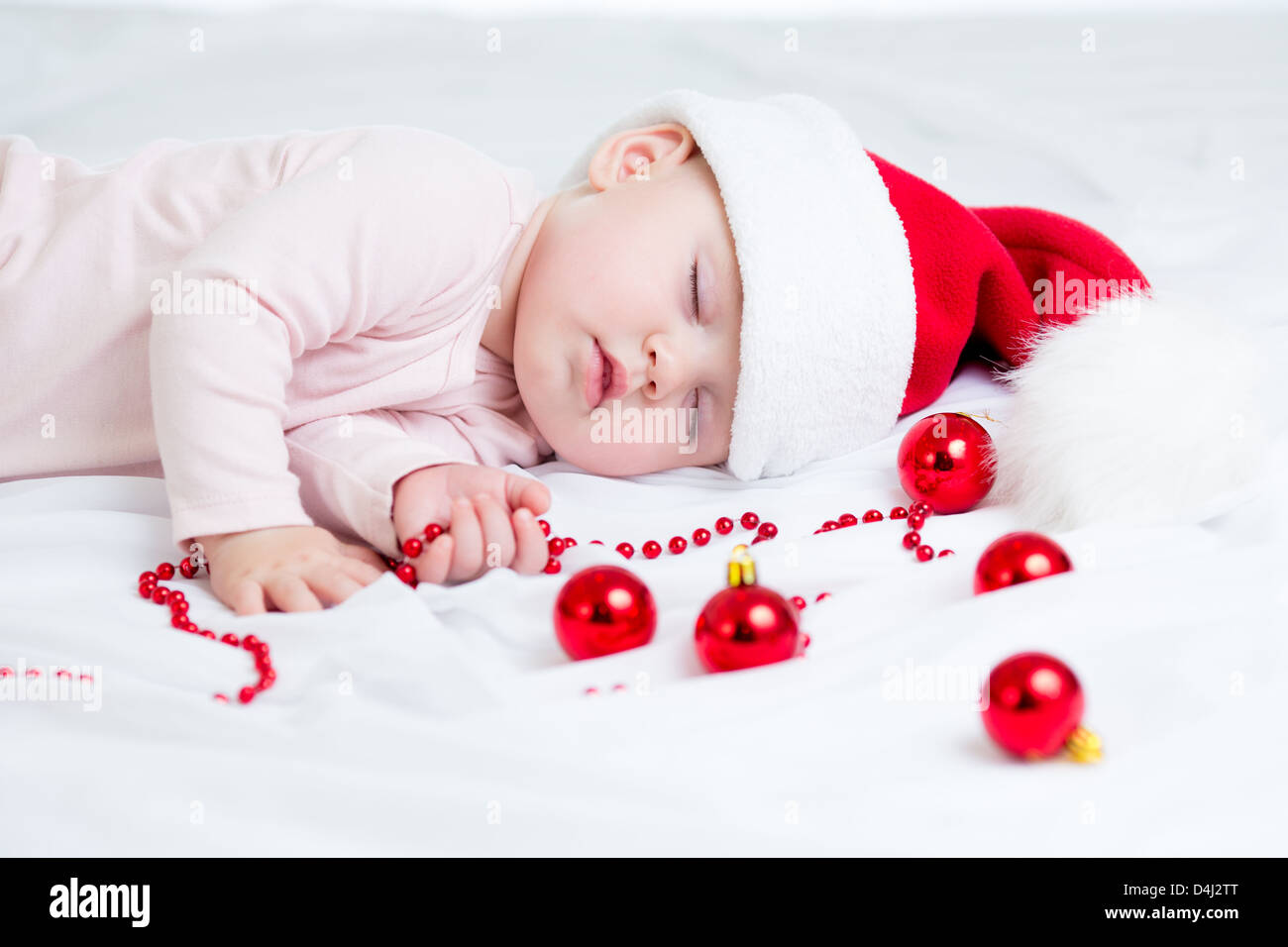 sleeping baby girl Santa Claus Stock Photo