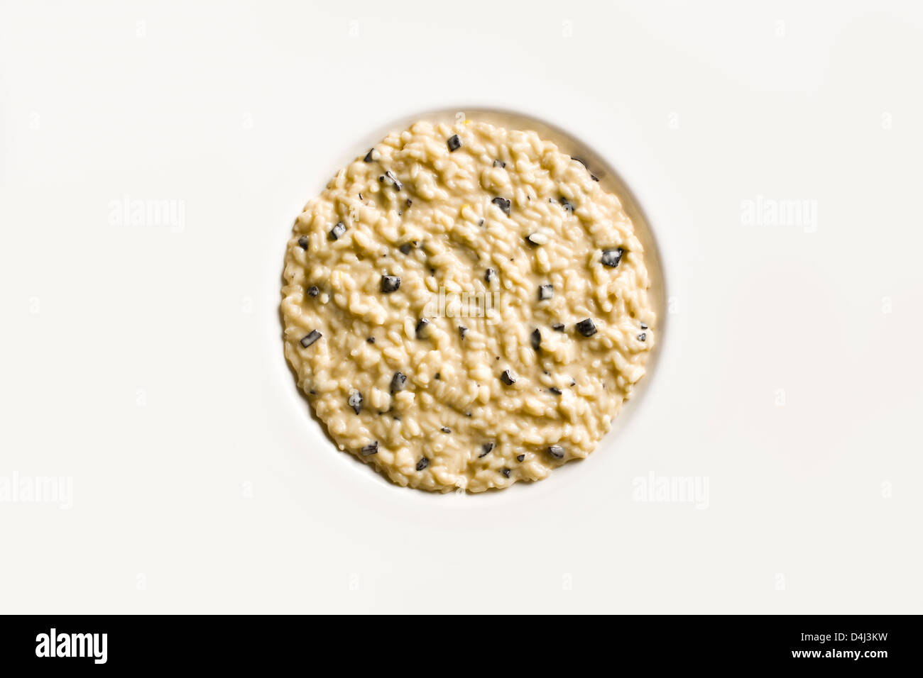 Risotto with Black Truffle on a white plate. Stock Photo
