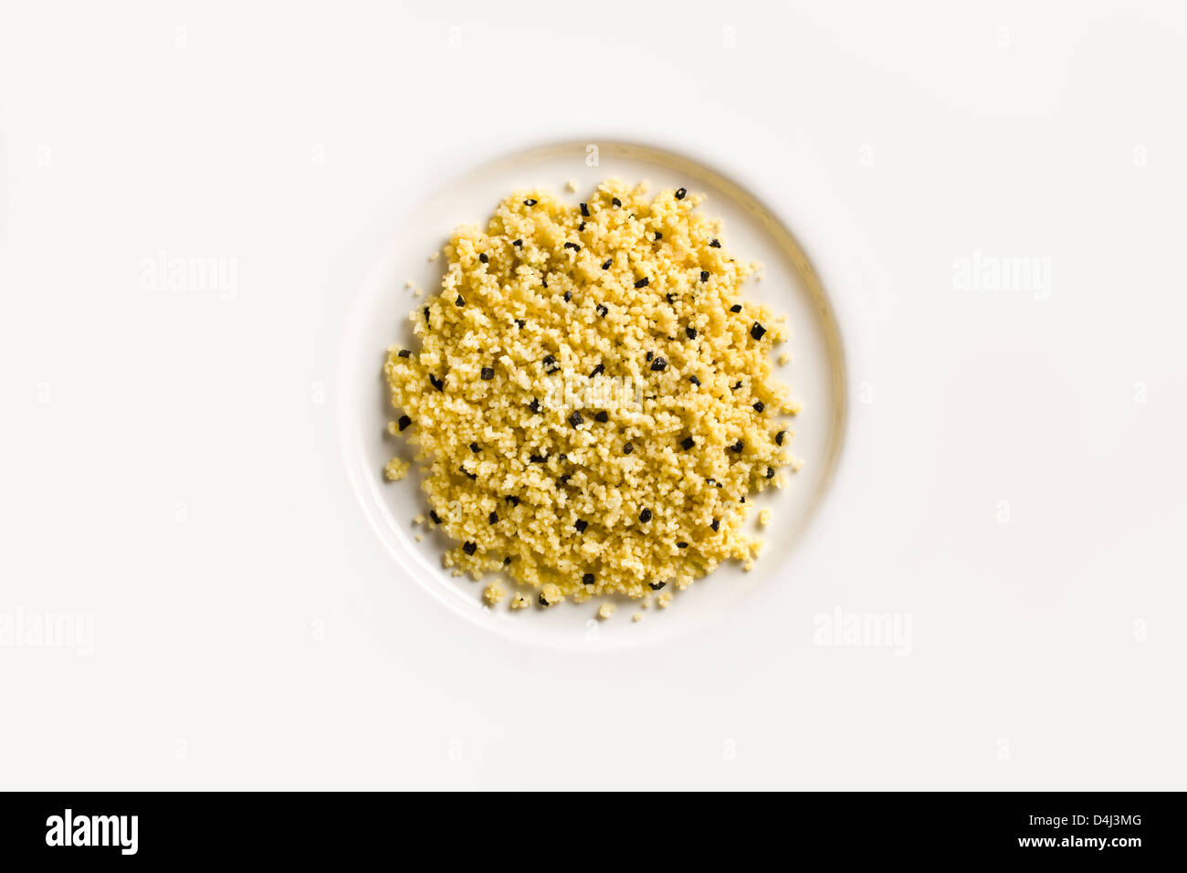 Cous Cous with Black Truffle on a white plate. Stock Photo