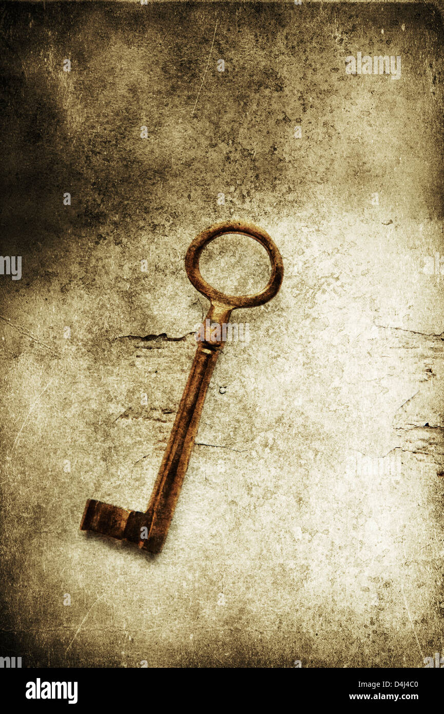 Old brass key on textured background Stock Photo - Alamy
