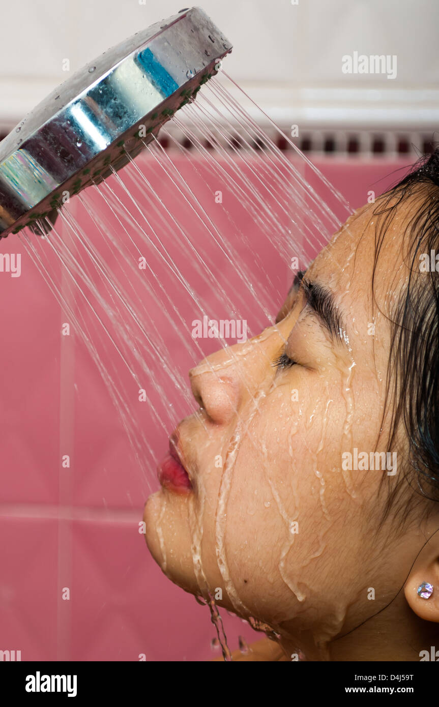 Cute Asian-Thai Girl is washing her face Stock Photo