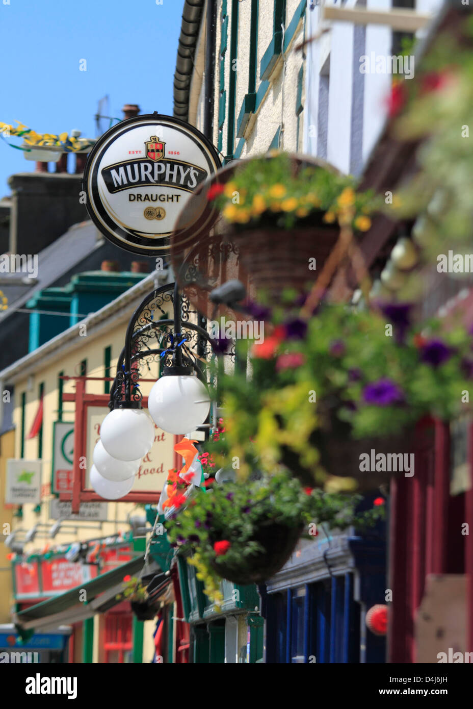 Traditional Irish Shop fronts and pub Murphys Irish Stout signs in the village of Schull, West County cork, Republic of Ireland Stock Photo