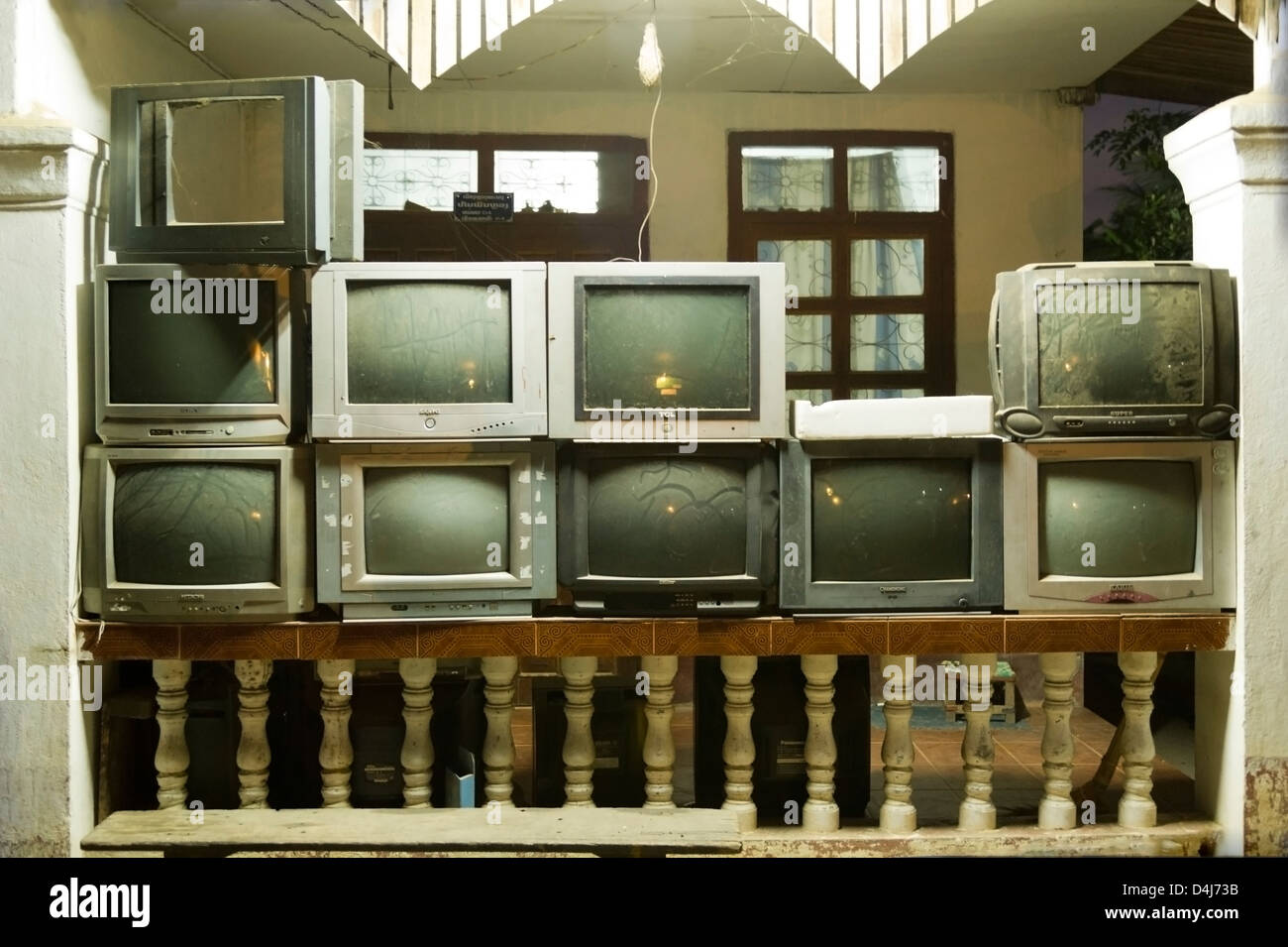 Dusty old televisions sit stacked on a veranda Stock Photo Alamy