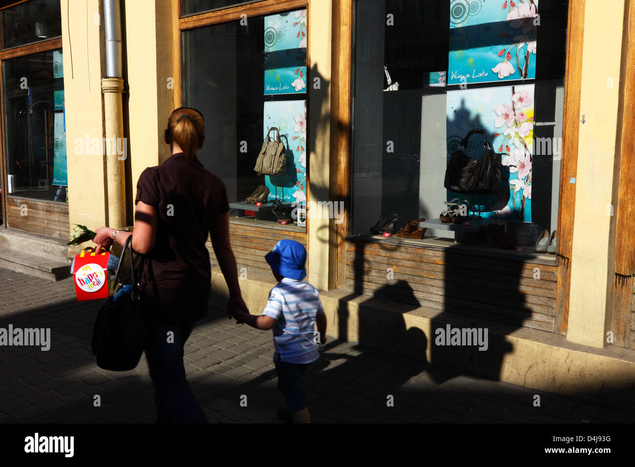 Mother and son with happy meal at Piotrkowska street. Lodz, Poland Stock Photo