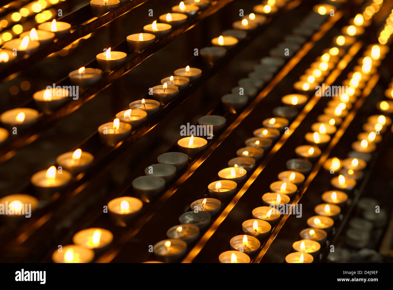 rows of burning candles in a catholic church Stock Photo Alamy