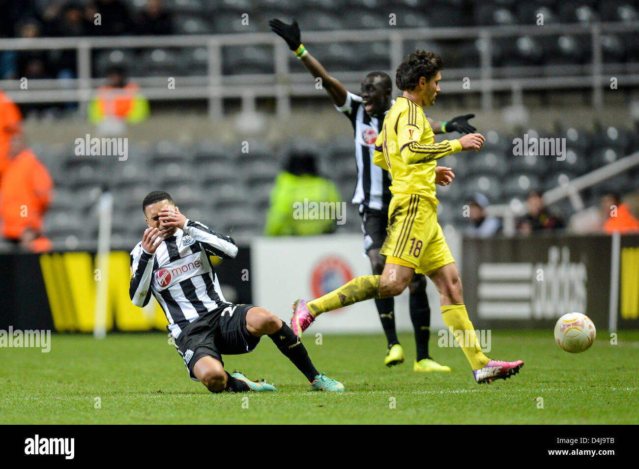 14.03.2013 Newcastle, England. Newcastle's Sylvain Marveaux goes down clutching his face after a high tackle from Yuri Zhirkov  during the Europa League game between Newcastle and Anzhi Makhachkala from St James Park. Stock Photo