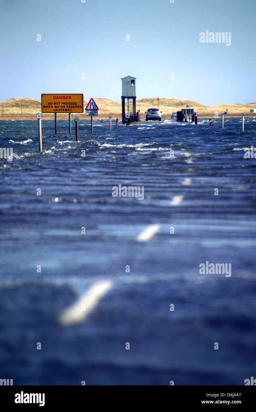 Cars stranded by high tide, causeway to holy island / lindisfarne, Northumberland Stock Photo