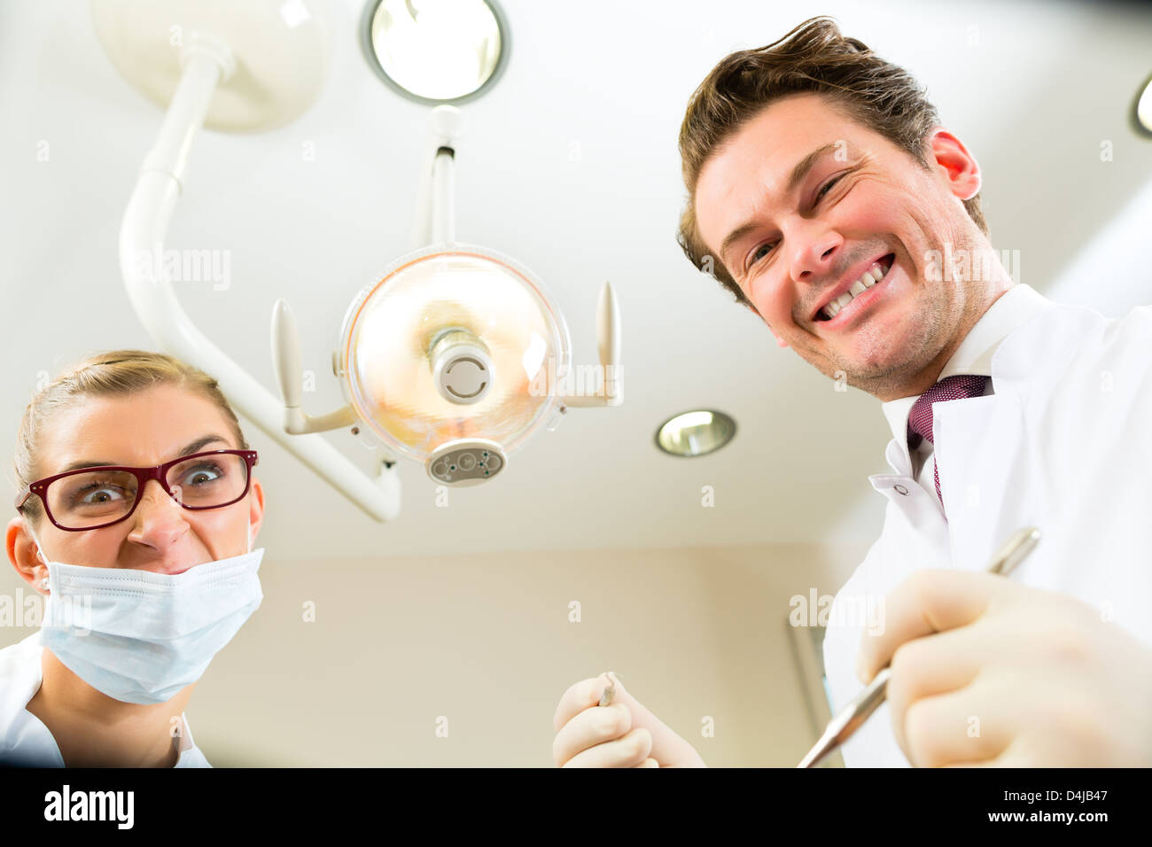 Scary dentist and assistant at a treatment, from the perspective of a