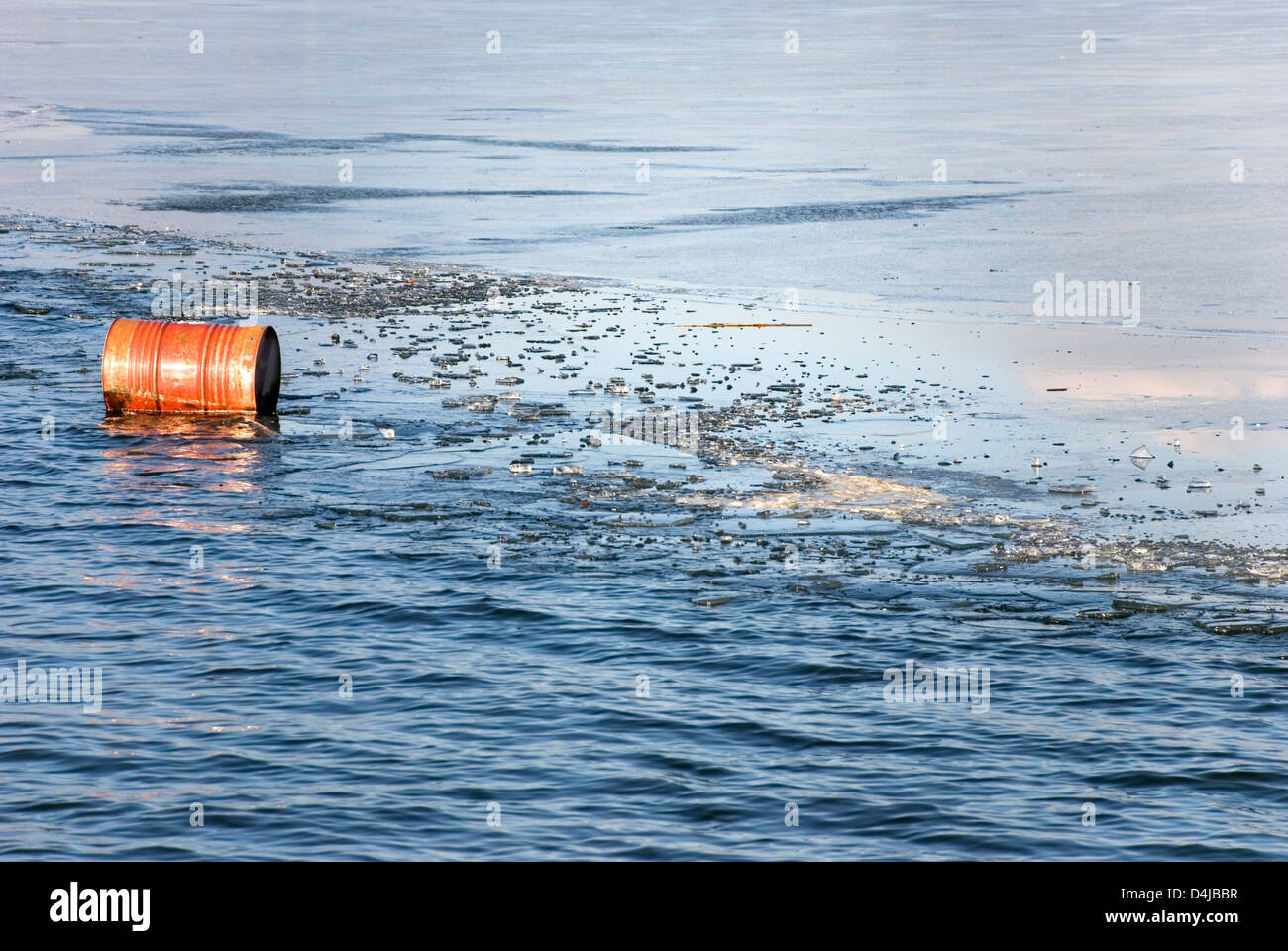 Oil barrel floating in icy water Stock Photo