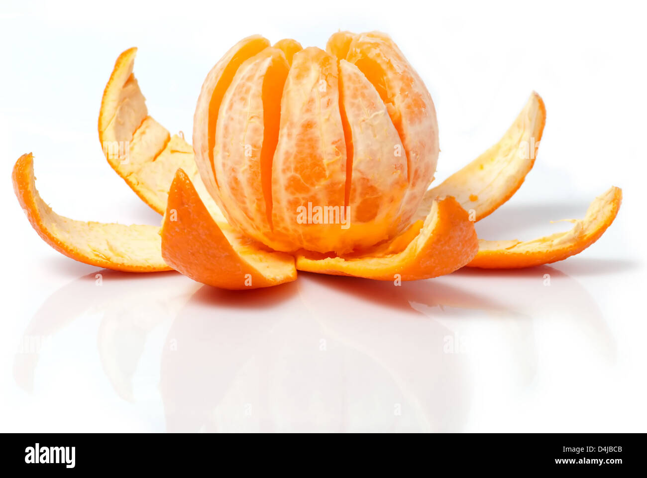 Unpeeled orange against white background Stock Photo