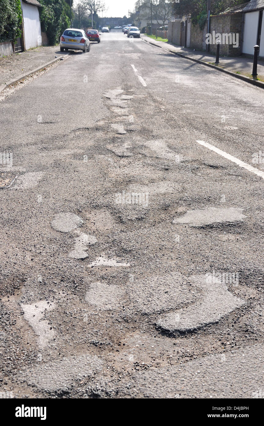 Potholes on Hithermoor Road, Stanwell Moor, Borough of Spelthorne, Surrey, England, United Kingdom Stock Photo