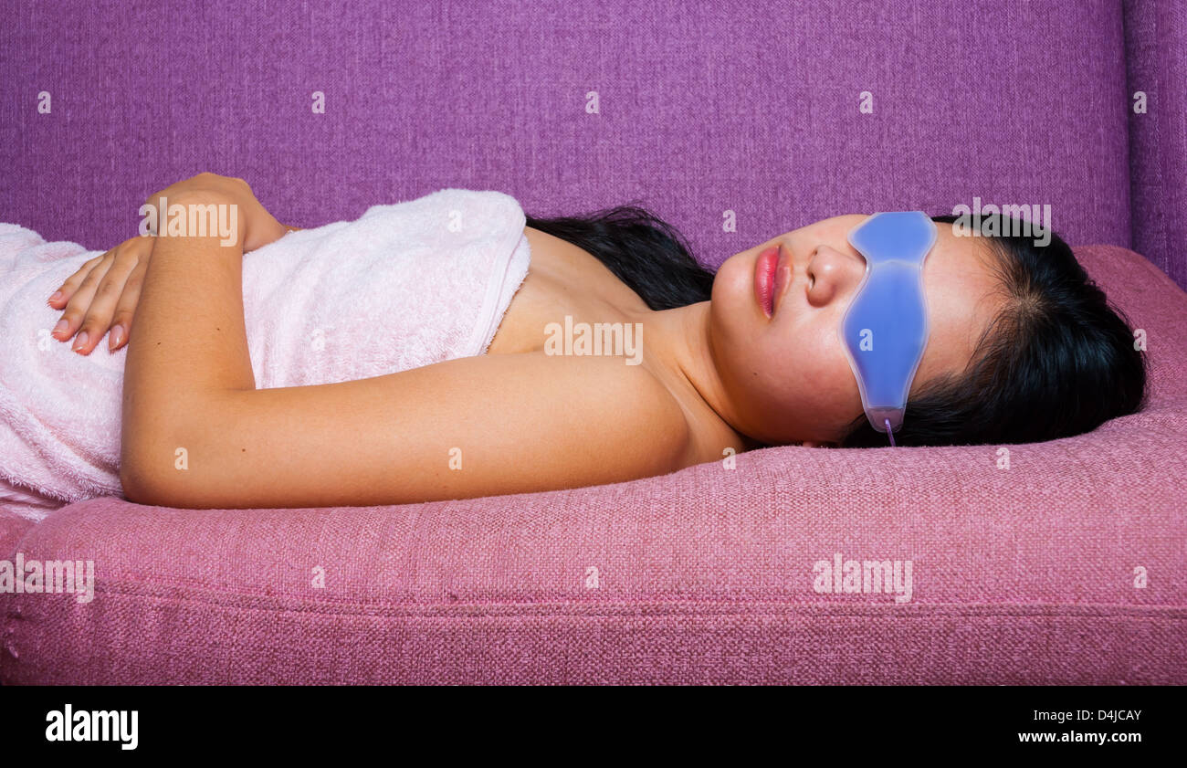 Cute Asian-Thai Girl with eyes gel mask which covering the upper part of the face but with holes for the eyes Stock Photo